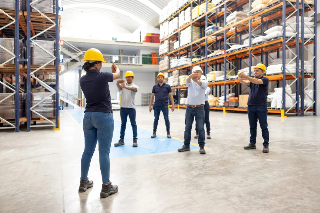 Warehouse employees taking an active break and doing stretching exercises