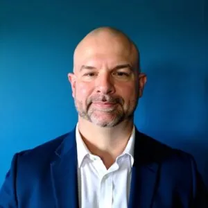 Headshot of author with blue background