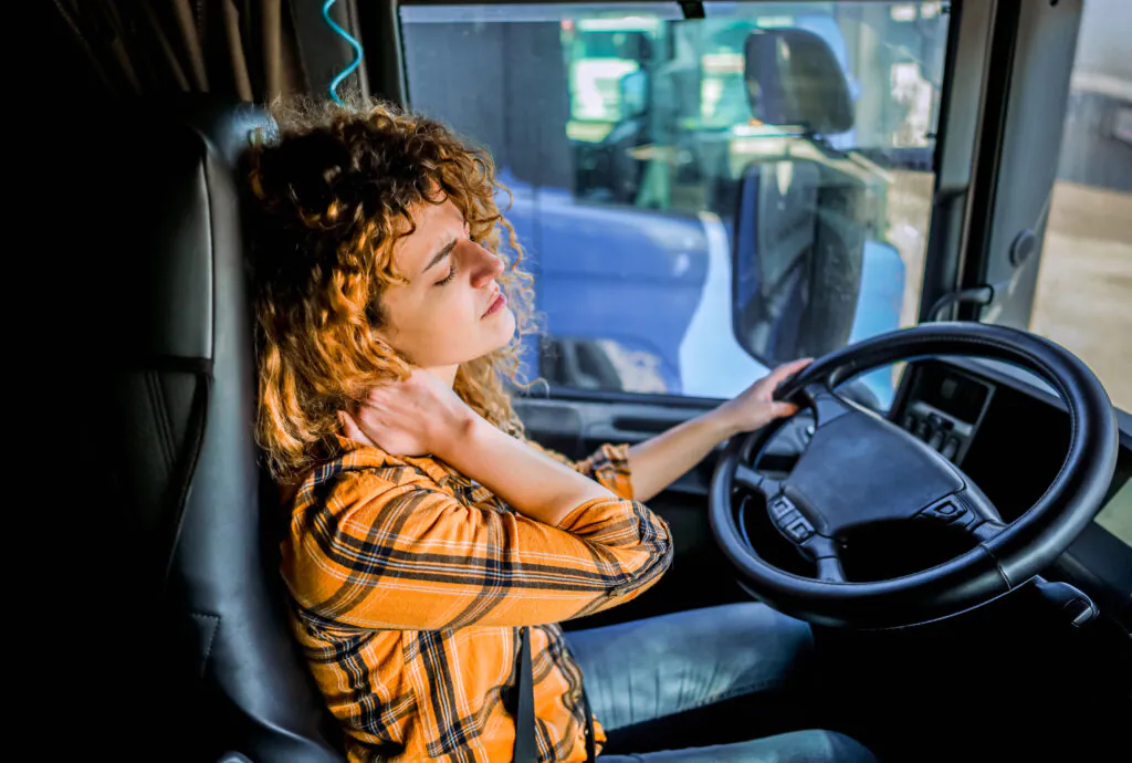 Female truck driver having neck pain