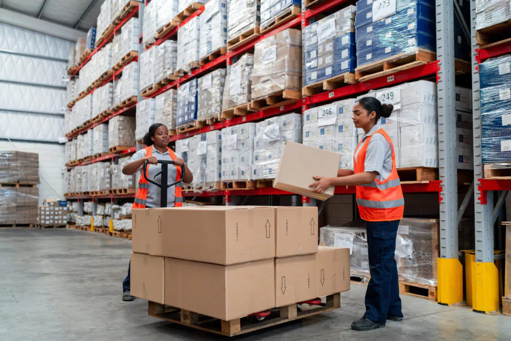 Team of workers moving boxes at a warehouse