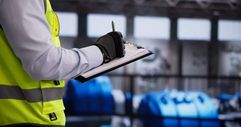 Safety Helmet-Wearing Engineer Conducts Detailed Inspection Of Gas Turbine Operation